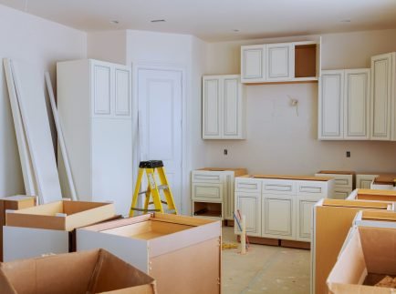 Custom kitchen cabinets in various stages of installation base for island in center Installation of kitchen cabinets