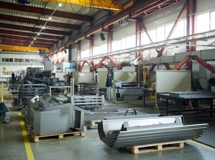 Wide angle background shot of empty factory workshop with machines ready for assembling, copy space